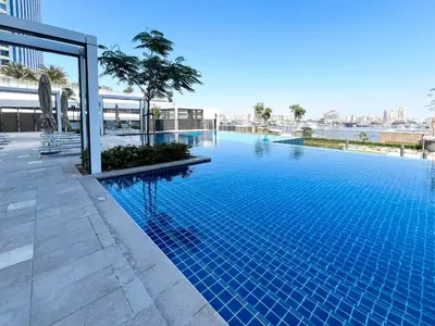 a large blue swimming pool on top of a building at Elegant 1 bedroom in Creek Edge in Dubai