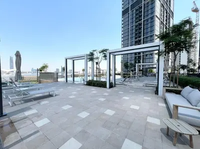 a large patio with benches and a building at Elegant 1 bedroom in Creek Edge in Dubai