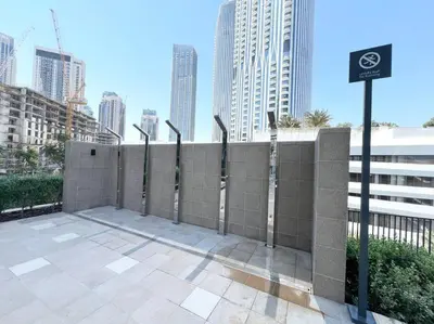 a retaining wall with a fence in a city at Elegant 1 bedroom in Creek Edge in Dubai