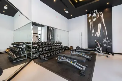 a gym with a lot of treadmills and machines at Spacious Luxe Studio Near Metro in Dubai