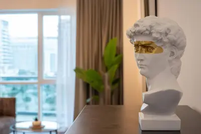 a statue of a bust on a table at Spacious Luxe Studio Near Metro in Dubai