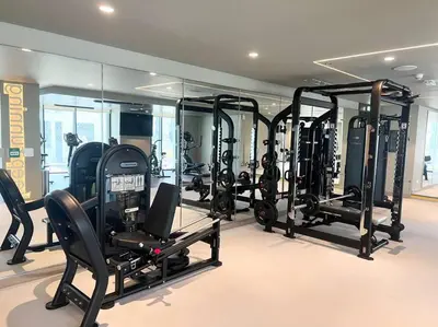 a gym with a lot of treadmills and ellipticals at Elegant 1 bedroom in Creek Edge in Dubai