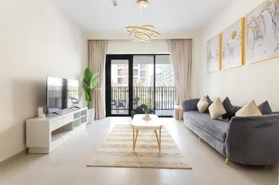 a living room with a couch and a tv at Elegant at Creek Beach 1 BHK in Dubai