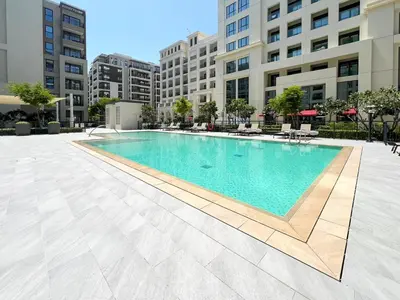a swimming pool in the middle of a building at Elegant at Creek Beach 1 BHK in Dubai