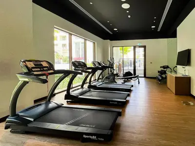 a gym with several treadmills in a room at Elegant at Creek Beach 1 BHK in Dubai