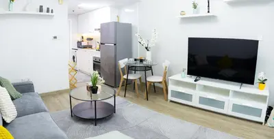 a living room with a large television and a table at Dubai Marina - Modern Design Studio Apartment, Marina Diamond 2 in Dubai