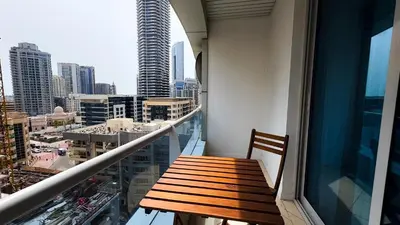 a wooden bench sitting on the balcony of a building at Dubai Marina - Modern Design Studio Apartment, Marina Diamond 2 in Dubai