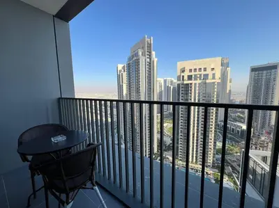 a balcony with a table and a view of a city at Stylish 1 Bedroom High Floor in Creek Edge in Dubai