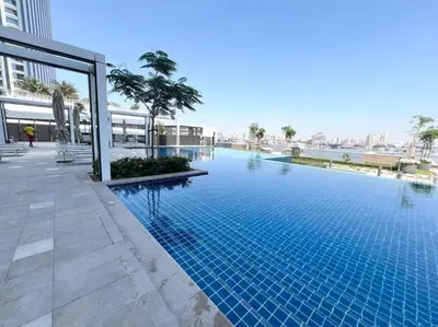 a large swimming pool in a building at Elegant 1 bedroom in Creek Edge in Dubai