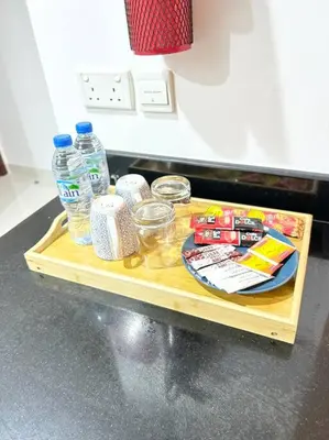 a table with bottles of water and other items on it at Prime Spacious Studio with Vibrant Vibes in JBR By SWEET HOMES in Dubai