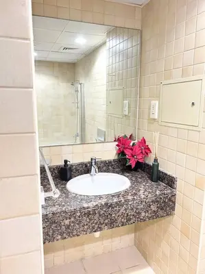 a bathroom with a sink and a mirror at Prime Spacious Studio with Vibrant Vibes in JBR By SWEET HOMES in Dubai