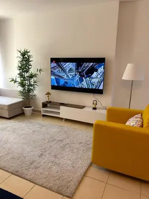 a living room with a large flat screen tv at Prime Spacious Studio with Vibrant Vibes in JBR By SWEET HOMES in Dubai