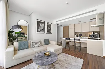 a living room with a couch and a table at Stonetree - Brand New 1 BR in Prime Location in Dubai