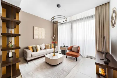 a living room with a couch and a table at Chic 1-Bed Near Marina Promenade - 5 min to Tram in Dubai