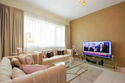 a living room with a couch and a flat screen tv at Stunning Marina view apartment In Marina sail tower by Truebleu vacation homes in Dubai