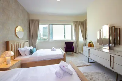 a hotel room with two beds and a window at Stunning Marina view apartment In Marina sail tower by Truebleu vacation homes in Dubai