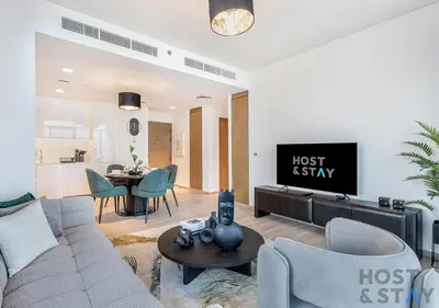 a living room with a couch and a table at 2-BR Getaway at Palace Residences, Dubai Creek in Dubai