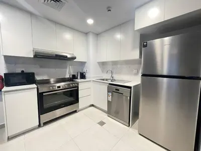 a kitchen with white cabinets and stainless steel appliances at Luxe & Comfy Madinat Jumeirah - Apartment with Scenic Views - Pool Managed by SunnyHomes in Dubai
