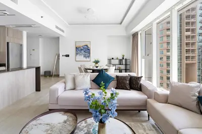 a living room with a couch and a table at Big 1BD in JLT - Pool, Game Zone in Dubai