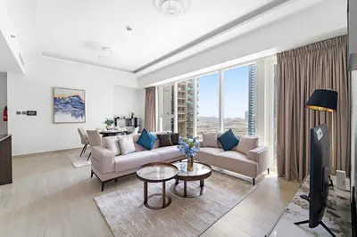 a living room with a couch and a table at Big 1BD in JLT - Pool, Game Zone in Dubai