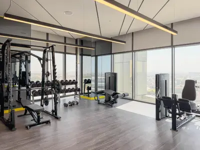 a gym with treadmills and cardio equipment in a building at Stylish Studio with Great Views High Floor in Dubai