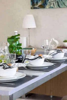 a table with plates and dishes on a table at Frank Porter - Al Majara Tower 2 in Dubai