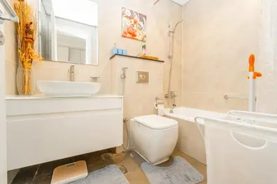 a bathroom with a white toilet and a sink at Sleek Studio in Damac Hills - Premium Living with Top-Class Amenities, Managed by Think Realty in Dubai