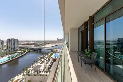 a balcony with chairs and a view of a river at Palace Residence, Dubai Creek Harbour - Mint Stay in Dubai