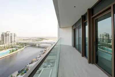a balcony of a building with a view of the water at Palace Residence, Dubai Creek Harbour - Mint Stay in Dubai