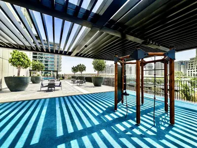 a swimming pool with a blue and white striped floor at Palace Residence, Dubai Creek Harbour - Mint Stay in Dubai