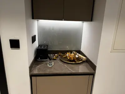 a kitchen counter with a plate of food on it at Cosy Studio on the Binghatti Canal in Dubai