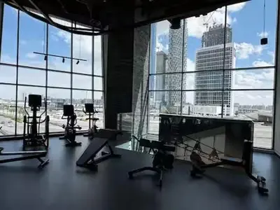 a gym with a view of a large window at Cosy Studio on the Binghatti Canal in Dubai