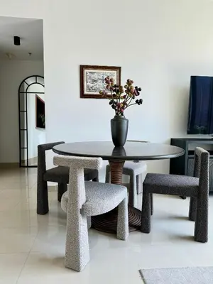 a table and chairs with a vase on top of it at Downtown,Fountain view, nearBurj Khalifa,3 minutes walk to Dubai Mall in Dubai