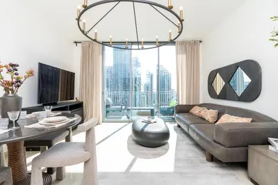 a living room with a couch and a table at Downtown,Fountain view, nearBurj Khalifa,3 minutes walk to Dubai Mall in Dubai