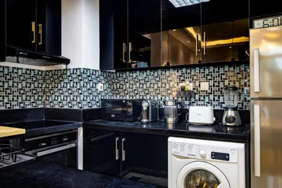 a kitchen with a washing machine in a kitchen at Vacation Friendly Beach View Luxury 1Bedroom- Walk To Beach & Mall in Dubai