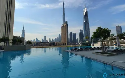 a swimming pool with a city skyline in the background at New Stylish 1BR Apartment, Next to Dubai Mall - Downtown Views ll, Tower 3 in Dubai