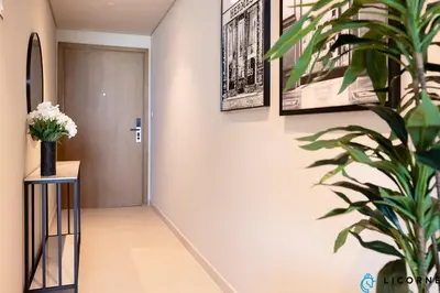 a hallway with a door and a potted plant at New Stylish 1BR Apartment, Next to Dubai Mall - Downtown Views ll, Tower 3 in Dubai