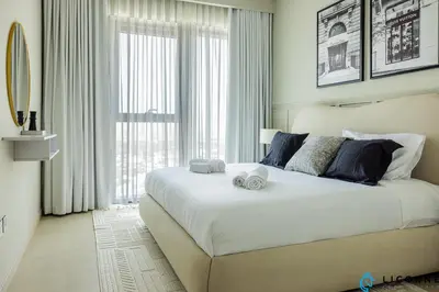 a bedroom with a large bed with two towels on it at New Stylish 1BR Apartment, Next to Dubai Mall - Downtown Views ll, Tower 3 in Dubai