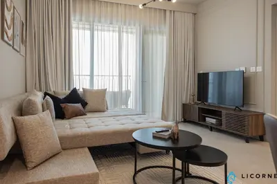 a living room with a couch and a flat screen tv at Top Floor Urban Oasis Steps from Dubai Mall - 1BR Apartment in Downtown Views ll, Tower 1 in Dubai