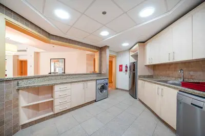 a large kitchen with a sink and a dishwasher at Spacious 3 Bedroom Palm Apartment in Dubai