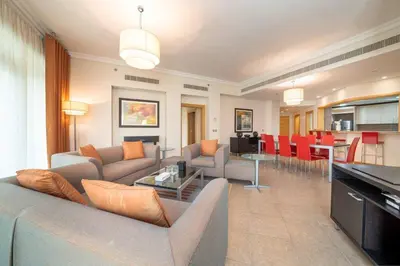 a living room with a couch and a table at Spacious 3 Bedroom Palm Apartment in Dubai