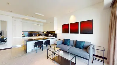 a living room with a couch and a kitchen at Vacationer l Bright 1 Bedroom l Marina & Yacht Views l Pool access & Free Wi-Fi in Dubai