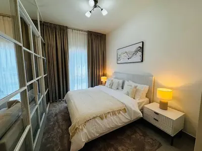 a bedroom with a large bed and a window at Golfville LighthouseDubai Hills in Dubai