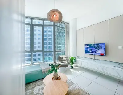 a living room with a large window and a tv at Amazing Roof Top Pool in Nice 1 BHK Flat in Marina in Dubai