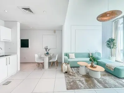 a living room with a blue couch and a table at Amazing Roof Top Pool in Nice 1 BHK Flat in Marina in Dubai