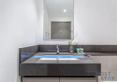 a bathroom with a sink and a mirror at Luxurious 2 BR- Dubai Creek Harbour - Host & Stay in Dubai