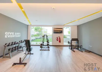 a gym with treadmills and machines in a room at Luxurious 2 BR- Dubai Creek Harbour - Host & Stay in Dubai