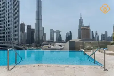 a large swimming pool with a city skyline in the background at Keysplease 3 BR Burj View, Dubai Mall Access Boulevard Point Tower in Dubai