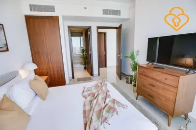 a living room with a bed and a flat screen tv at Keysplease 3 BR Burj View, Dubai Mall Access Boulevard Point Tower in Dubai