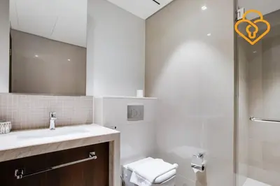 a bathroom with a sink and a toilet and a mirror at Keysplease 3 BR Burj View, Dubai Mall Access Boulevard Point Tower in Dubai